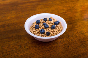 Toasted Oat Cereal in White Bowl and Blueberries