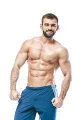 Fototapeta na wymiar bodybuilder posing. Beautiful sporty guy male power. Fitness muscled in blue shorts. on isolated white background. Man with muscular torso. Strong Athletic Man Fitness Model Torso showing six pack abs