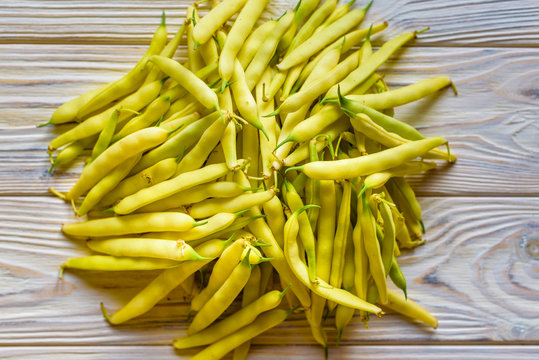 yellow beans on a wooden background.