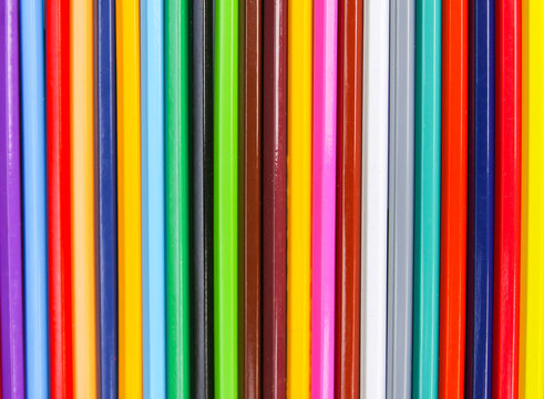 Bright colored pencils. Creative supplies background.
