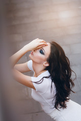 Girl with long hair in elegant white dress