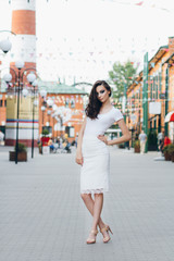 Girl with long hair in elegant white dress