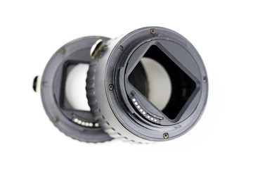 Intermediate ring for macro photography on a white table. Photo accessories for photographic shooting.