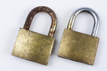 Brass padlock on a white table. Accessories for locking and securing against burglary.