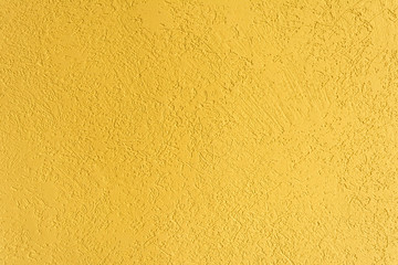 Fototapeta premium texture of the surface of the wall covered with decorative plaster of the woodworm type