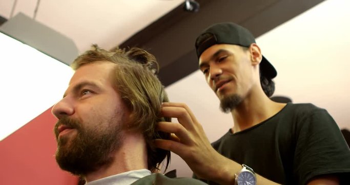 Man getting his hair cut by hairdresser 4k