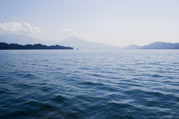 blue waves on a lake with mountains in the background