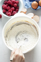 Mixing flour in chocolate brownies batter 