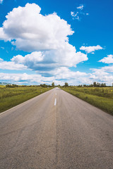 Open road and cumulus clouds, Vrsac, Serbia