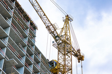 Fototapeta na wymiar Construction site with cranes and building with blue sky