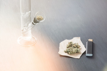 Bong and marijuana, cannabis thc flower Sativa and Indica Close up on a black background. lifestyle...