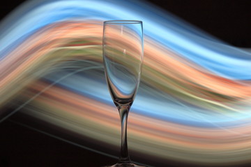 Night photo of champagne glass with bright lights
