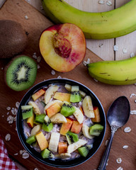 Breakfast with oatmeal porridge with fruits. Oatmeal with kiwi, peach and banana. Healthy breakfast concept. Top view