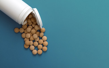 White medical pills container on blue background
