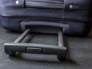 close up baggage case handle grip on a dark surface