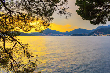 Awesome colorful sunset on Adriatic sea coastline in Montenegro, gorgeous summer seascape and nature landscape