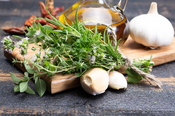 Aromatic fresh kitchen herbs, garlic, onion and olive oil, main ingredients for many dishes in...