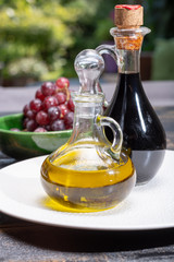 Black aged natural balsamic vinegar dressing from Modena, Italy and high quality olive oil