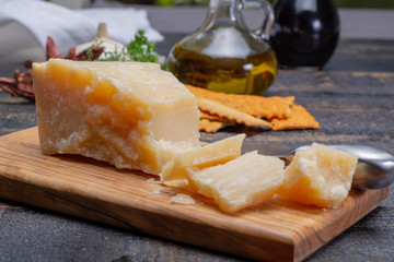 Traditional italian food - 36 months aged in caves Italian parmesan hard cheese from Parmigiano-Reggiano, Italy