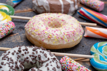 Children party background with sweet colorful donuts and candy