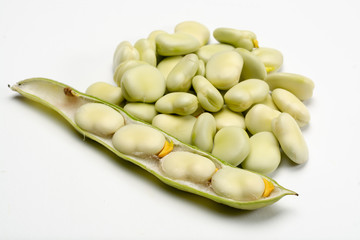 New harvest of healthy vegetables, green fresh raw big broad beans close up isolated on white background