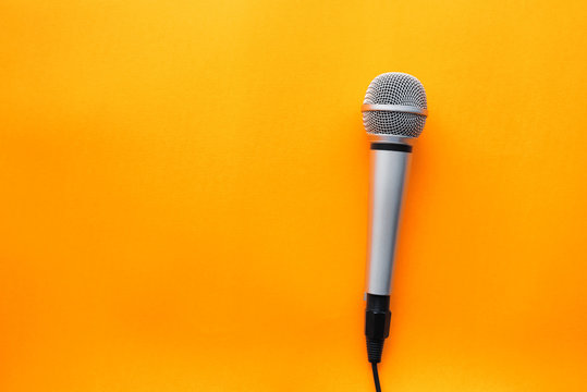 Microphone on yellow background