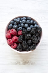 Full bowl of berries, top view. Summer berry. From above, overhead.