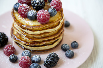 Pancakes with berries, side view. Summer breakfast. Closeup.