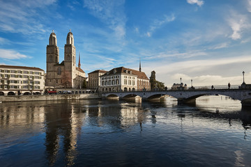 View of historic city of Zurich. Grossmunster Church and Munsterbucke crossing river Limmat, Canton of Zurich, Switzerland
