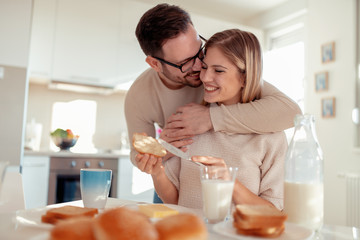 Young couple having breakfast at home