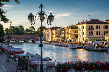 Boats and the bridge in port on Lake Garda, Peschiera del Garda - obrazy, fototapety, plakaty