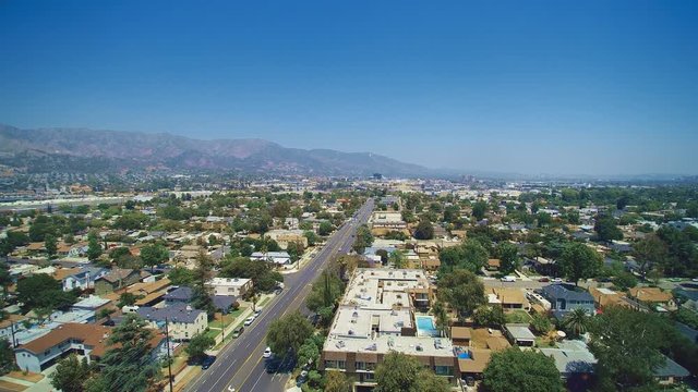 Aerial shot of neighborhoods by mountains in the valley in California