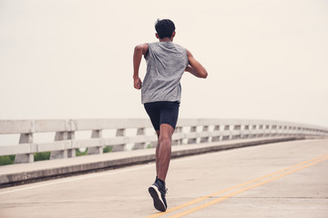 Fototapeta premium Black men runner are running on the bridge.black man doing workout outdoors,