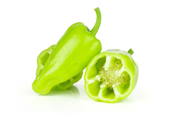 Group of one whole two halves of light green bell pepper isolated on white.