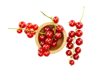 Red currant berry in a wooden bowl two strings is near it flatlay isolated on white.