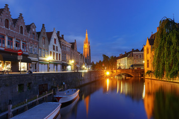 Fototapeta na wymiar Scenic cityscape with a medieval fairytale canal and the quay Dijver and Church of Our Lady at night in Bruges, Belgium