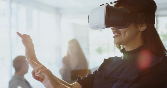 Businesswoman using virtual reality headset 4k