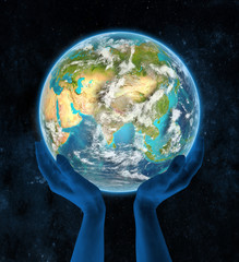 Nepal on planet Earth in hands