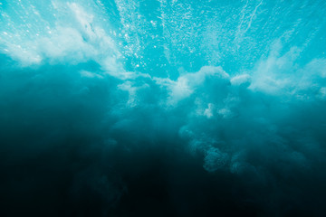 Obraz premium Breaking ocean wave is underwater. Ocean texture in underwater