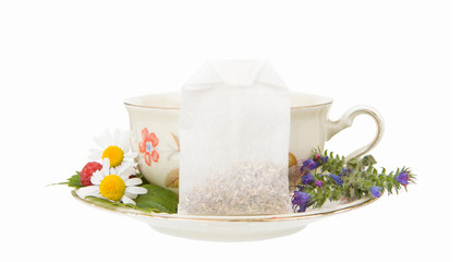 Herbal Tea Bag with Chamomile and Wildflowers on Floral Teacup and Saucer