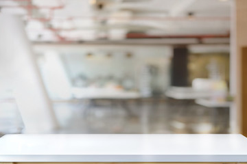 Empty wooden table in office for product display montage.