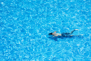 Children diving in a pool in summer