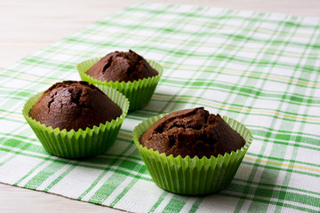 Chocolate muffins in the green wrappers, copy space