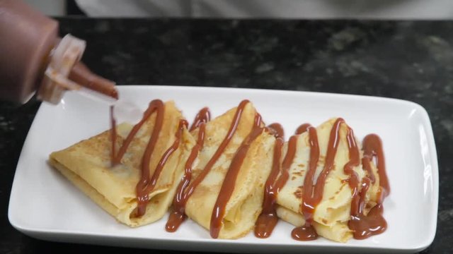 Cooking sweet crepes with cajeta