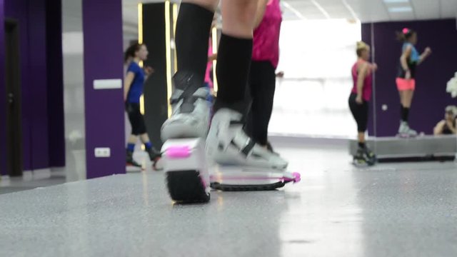 Close up of bouncing stilts in a group fitness class.