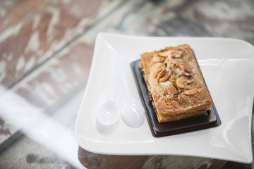 Pieces of nut cake on wooden table.