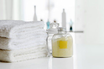 White bath towels and bottle of spa powder