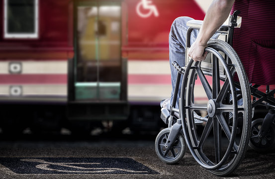 Cropped image of man in his wheelchair at railway station platform