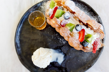 Baked traditional Belgium waffles with ice cream .