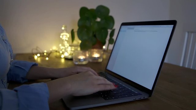 A woman typing at a macbook